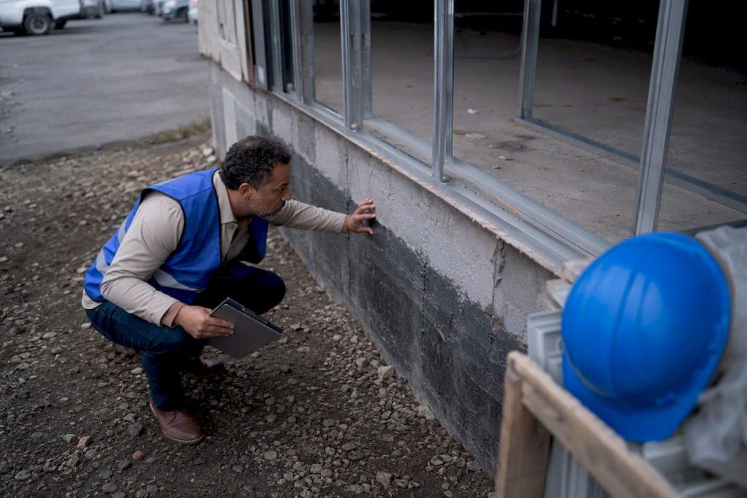 Investor measuring commercial building facade