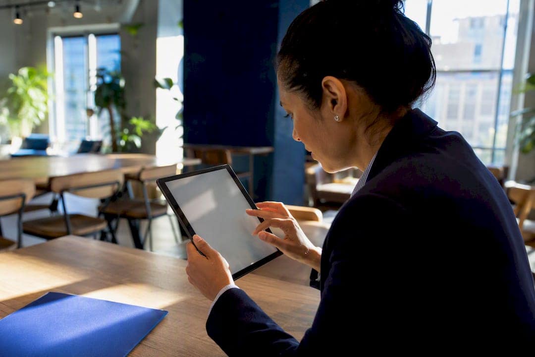 Compliance officer verifying ownership on tablet