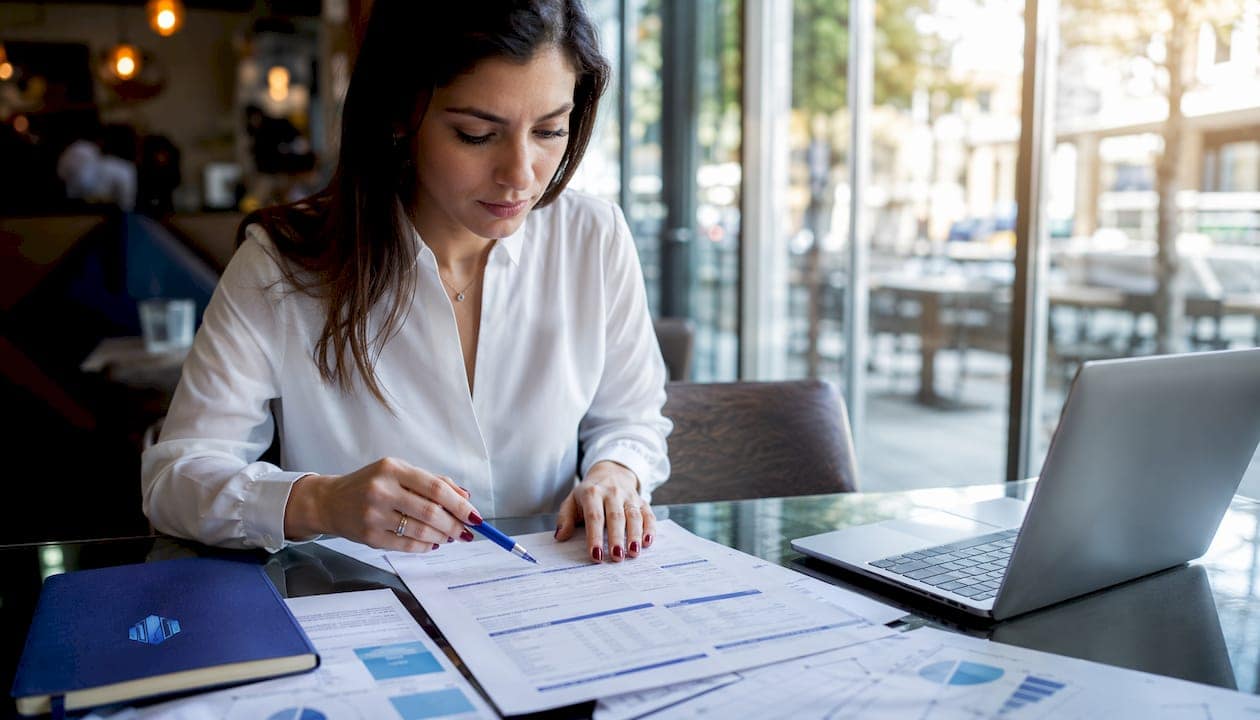 Hands pointing to financing documents on desk