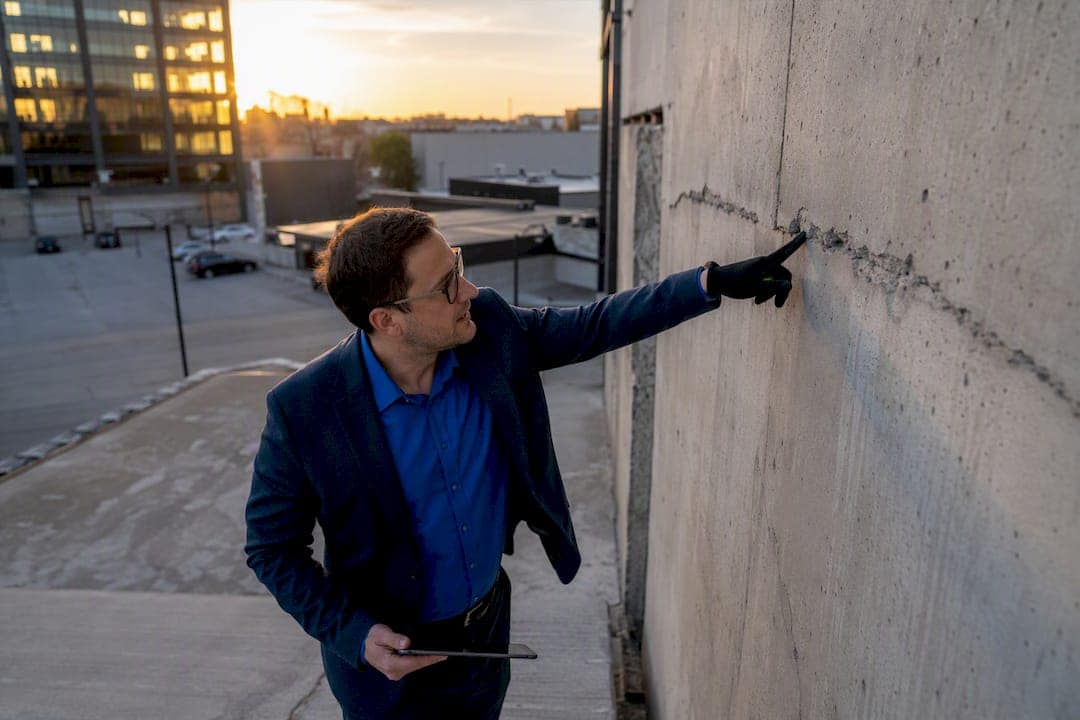9 Loan Origination Efficiency Metrics Every Lender Should Track 3 Investor inspecting commercial property defect