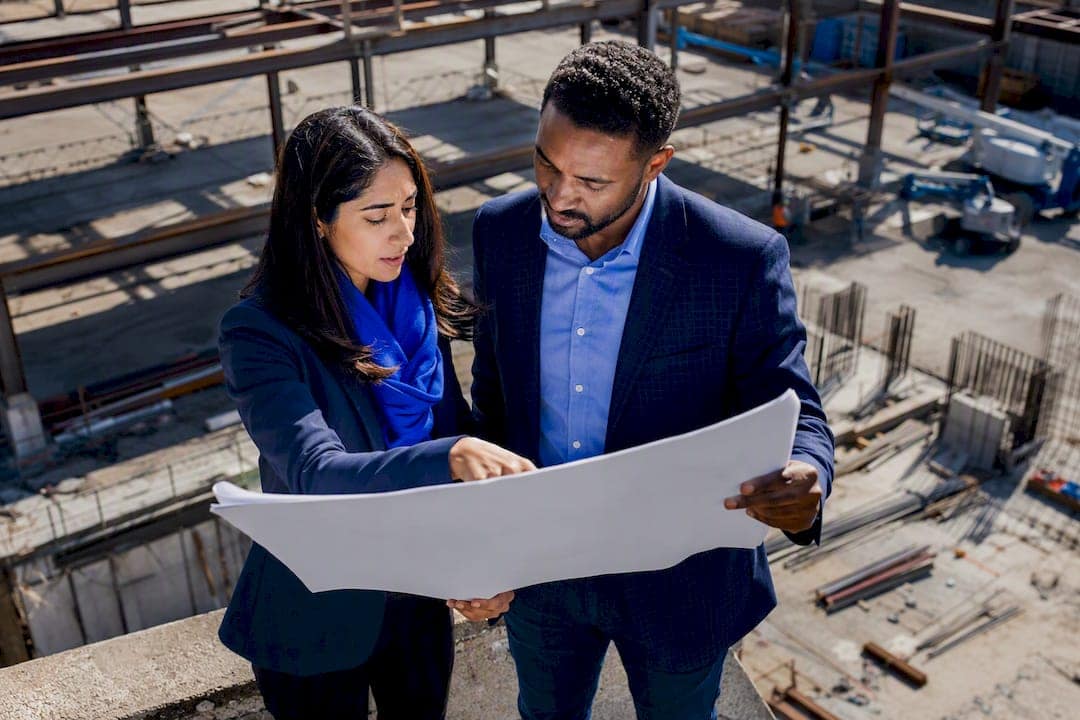 Investors reviewing commercial real estate plans outdoors